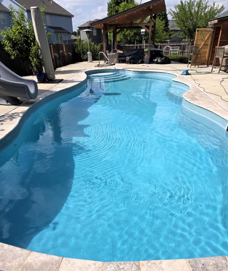 Freeform fiberglass pool with slide - Pools By York